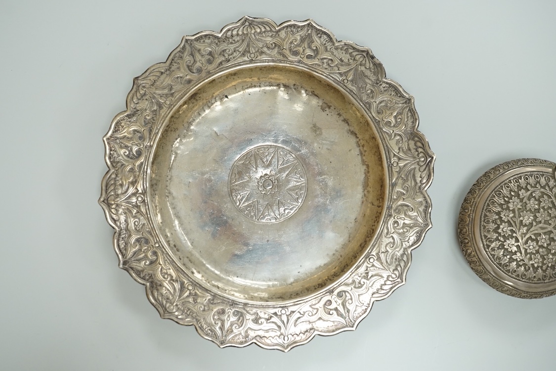 A Thai white metal tobacco box, embossed with foliage, diameter 72mm together with a similar dish.